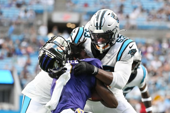 Aug 21, 2021; Charlotte, North Carolina, USA; Carolina Panthers defensive end Brian Burns (53) knocks off the helmet of Baltimore Ravens quarterback Tyler Huntley (2) during a tackle in the first quarter at Bank of America Stadium.
